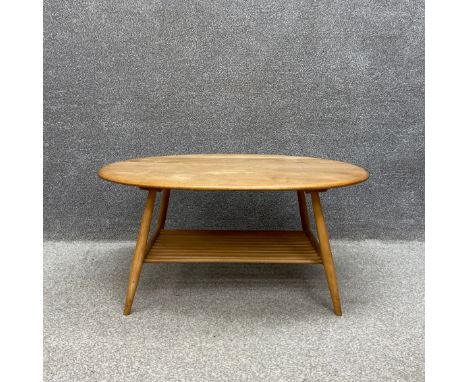 A mid-century oval beech and elm Ercol coffee table, model 454. H.44 W.99 D.83cm