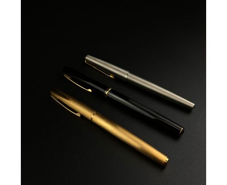 A collection of three pens to include a faceted black Waterman Concorde fountain pen with an 18k gold wraparound nib, a rolle