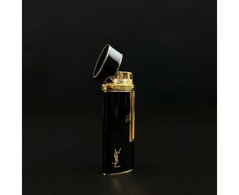 A vintage Yves Saint Laurent gilt and black lacquered Colibri cigarette lighter with maker's marks throughout. H.7.5cm 