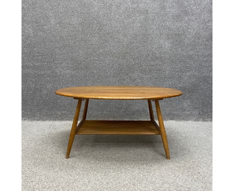 A mid-century oval beech and elm Ercol coffee table, model 454. H.44 W.99 D.83cm