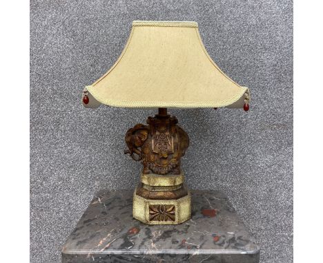 A contemporary Eastern carved and painted figural elephant table lamp on a moulded and faceted base. H.38cm (not including sh