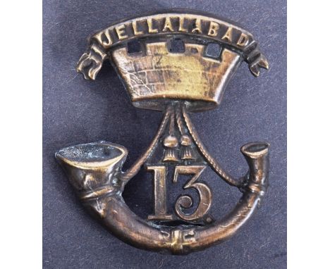 A 19th Century Victorian 13th (Somerset Light Infantry) Regiment of Foot Glengarry cap badge. The badge depicting a stringed 