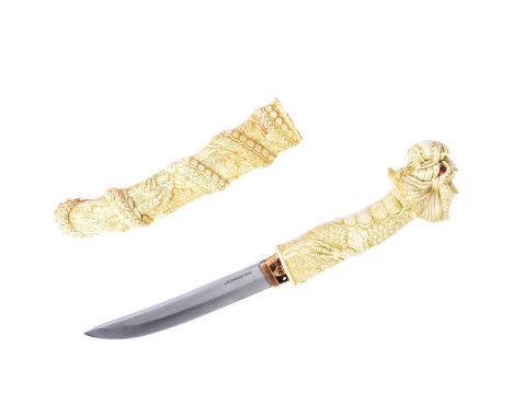 A vintage Japanese style Tanto knife. Resin construction carved to a mythical dragon wrapping around the length of the scabba