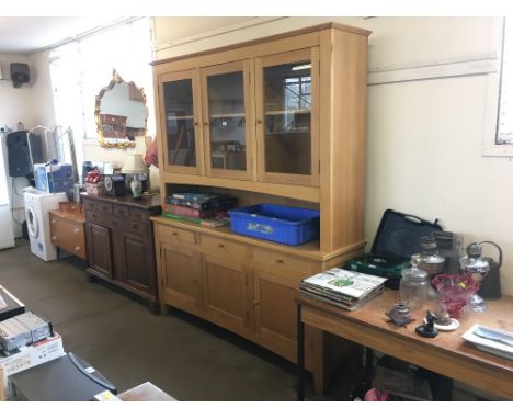 A light oak dresser raised on cupboard base fitted three drawers 