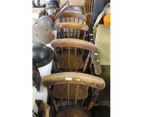 A set of four stick back dining chairs