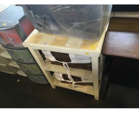 A kitchen unit with tile top and wicker drawers