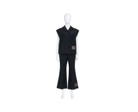 A GUCCI SLEEVELESS TAILORED SUIT JACKET AND MATCHING FLARED TROUSERS
Including a black sleeveless double-breasted jacket with