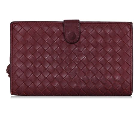 A BOTTEGA VENETA RED LEATHER WALLET
Signature Intrecciato weave, snap button closure, side zipper compartment, including card