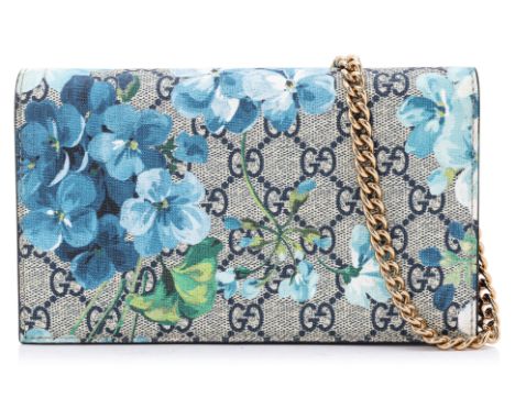 A GUCCI FLORAL PRINT WALLET ON CHAIN
'GG' monogram coated canvas in blue, with a floral pattern overlay, features a flap that