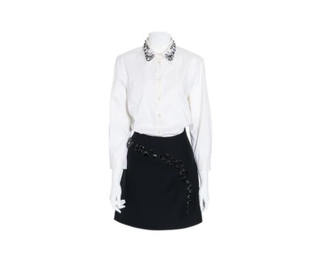 A PRADA EMBELLISHED SHIRT AND SKIRT
Including a white button-down shirt with embellished collar; and black mini skirt with an