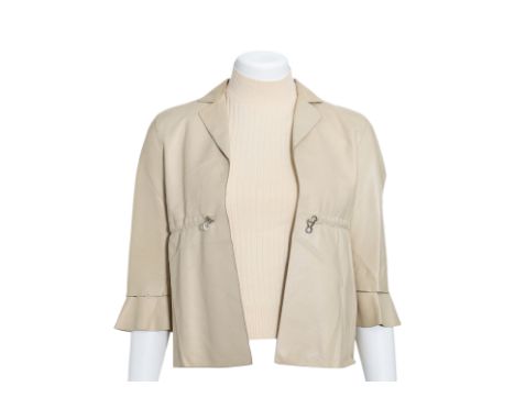 A PRADA BEIGE LEATHER JACKET AND SLEEVELESS SWEATER
Featuring a collared neckline and adjustable drawstring detail at the wai