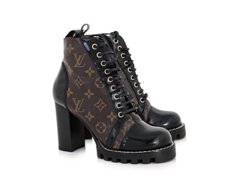 A PAIR OF LOUIS VUITTON STAR TRAIL ANKLE BOOTS
Signature monogram canvas, leather and rubber trim, lace-up closure with conce