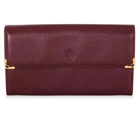 A CARTIER LEATHER WALLET
Circa 1990s, burgundy leather with embossed logo and brass mounted corners, with card and box
19 x 1