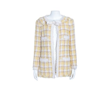 A CHANEL YELLOW TWEED JACKET
Rounded neckline with a tie and button closure at the front, flat lay collar, padded shoulders,.