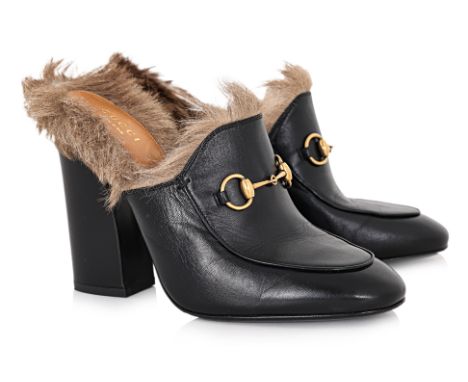A PAIR OF GUCCI PRINCETOWN HIGH HEELED MULES
Black leather body, fur trim, gold-tone horsebit detail on the vamp, and a block