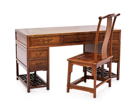 A CHINESE ELM TWIN PEDESTAL DESK AND CHAIR
Rectangular desk in elm with camphor lined drawers, brass loop handles, lattice sh