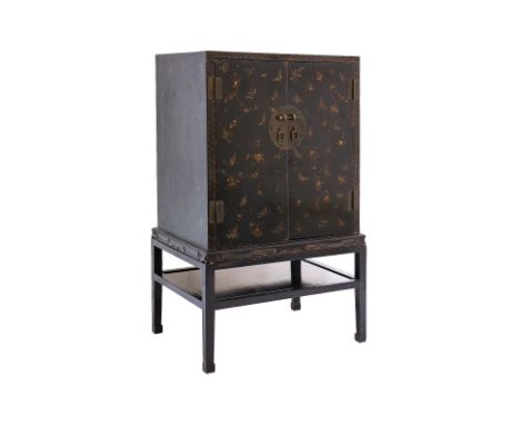 A LACQUERED BUTTERFLY CABINET ON STAND
Chinese, black lacquered, front and sides decorated in numerous gold painted butterfli