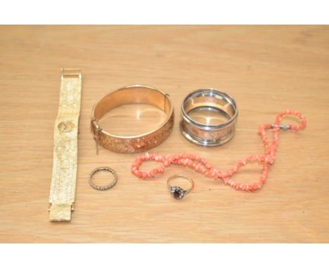 A gold plated engraved hinged bangle, along with a Rotary wristwatch, coral chip necklace, two rings and a silver napkin ring