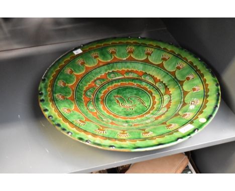 A large vintage terracotta Spanish dish, beautifully decorated depicting rooster on a green glaze ground, 49cm.