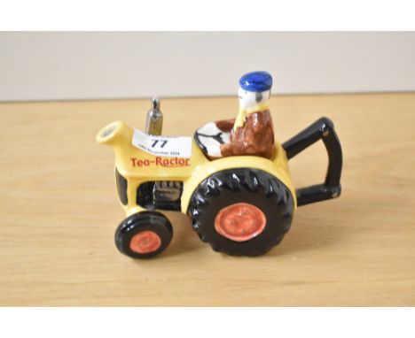 A 1960's novelty ceramic teapot in the shape of a tractor, finished in glazed paint, factory mark to base 'Tony Carter', h10c