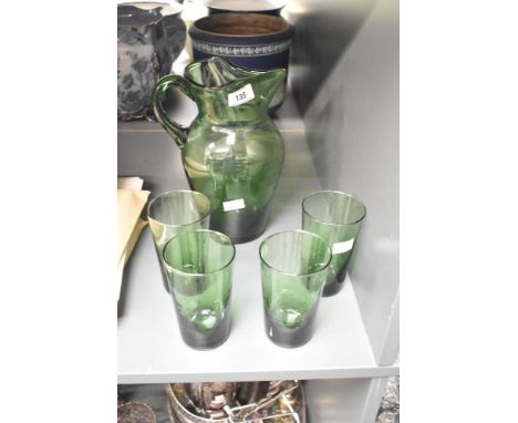 A vintage hand blown green glass pitcher with pinched spout, sold alongside four matching green glasses, pitcher 24cm.