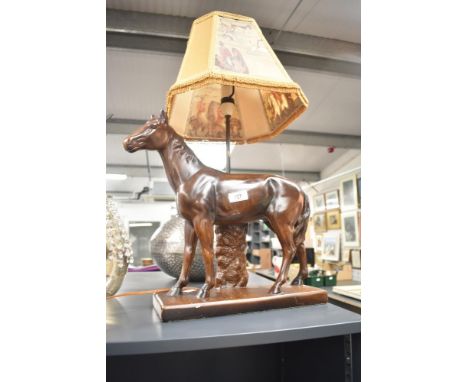 A 20th century equestrian ceramic table lamp with a mustard frilled shade depicting a hunting scene, 63cm.