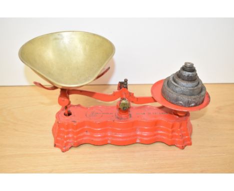 A heavy cast iron weighing scale in original red paint, impressed factory mark 'fibra seale co', L30cm