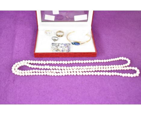 A 9ct gold white stone cluster ring (marked 375) sold along with a long fresh water pearl necklace, two white metal rings and