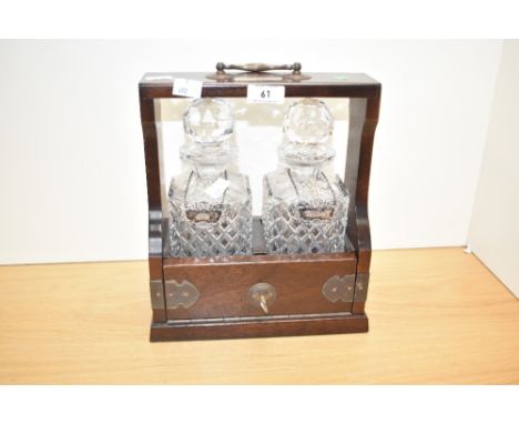 A quality 20th century solid mahogany two-bottled crystal Tantalus with sherry and gin label stamped London 1972, Richard and