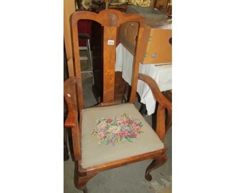 An oak elbow chair with tapestry seat.