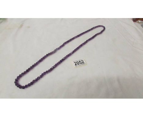 A natural amethyst stone necklace, vibrant colour, 32" long.