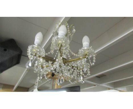 A 6 lamp glass chandelier.