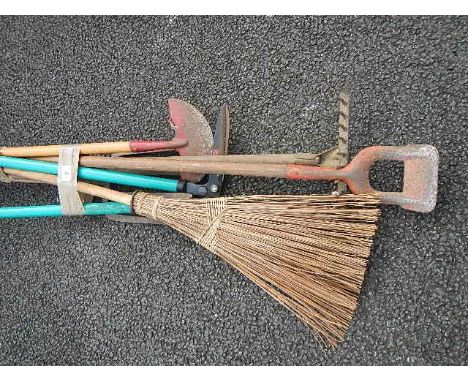 A quantity of assorted garden tools.