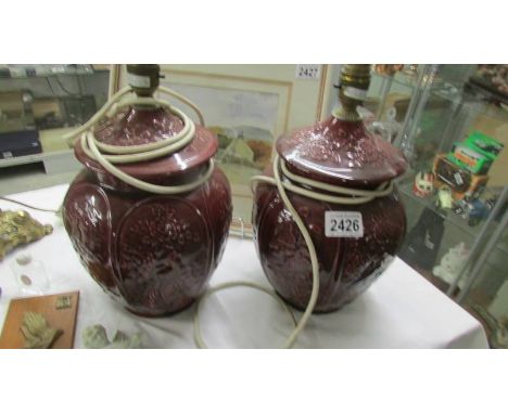 A pair of plum coloured ceramic lamp bases.