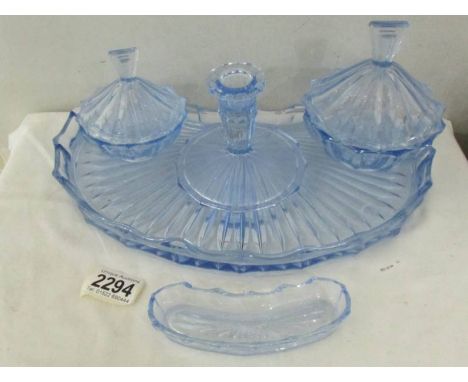 A blue glass trinket set with tray.