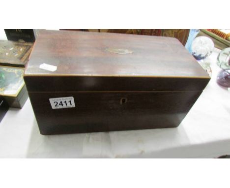 A Victorian mahogany tea caddy (missing one internal lid and mixing bowl.).