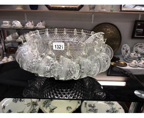 A large punch bowl complete with 18 glasses and hooks, plus ladle and stirrer