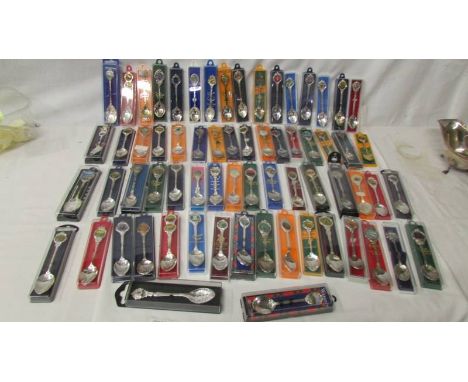 In excess of 60 souvenir spoons including enamel examples.