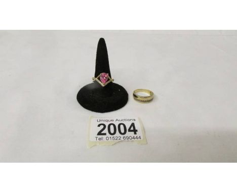 A silver gilt ring marked 925, size N together with an unmarked stone set yellow metal ring, size M.