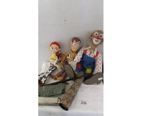 A vintage clown doll, 2 Toy Story talking dolls, a Hohner harmonica, a kaleidescope and a penny whistle.