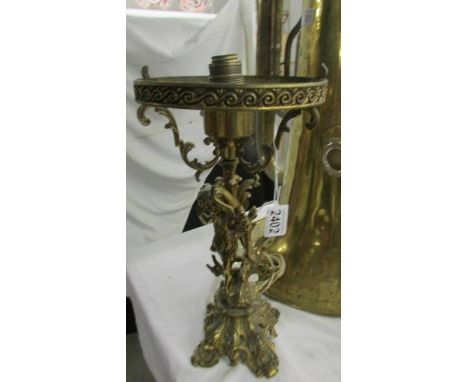 A heavy brass cherub table lamp (in need of re-wiring).