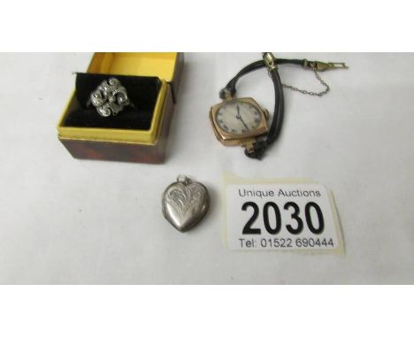 A silver heart locket, a silver ring and a ladies gold watch.