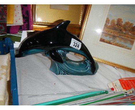 A blue Poole dolphin figure.