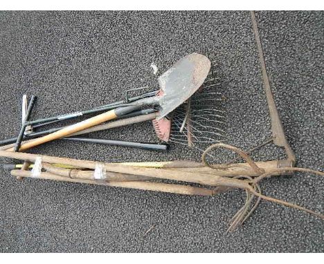 A quantity of assorted garden tools.