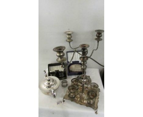 A mixed lot of silver plate including candelabra, teapot, egg cup stand, napkin rings etc.,