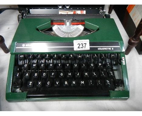 A Silver Reed 'Silverette' portable typewriter in green,.
