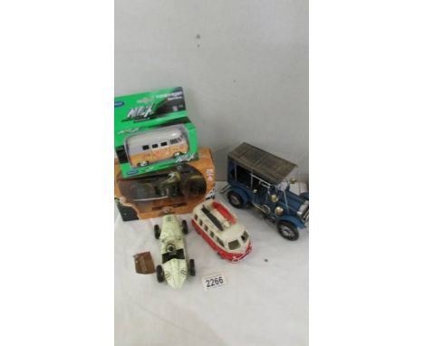 A boxed Indian Chief motor cycle, a boxed VW camper van, another VW camper van, a vintage car and a sports car.