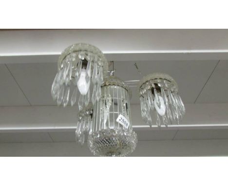 A 3 lamp glass chandelier. ****Condition report**** Glass domes are moulded, domes on top centre and bottom centre both glued
