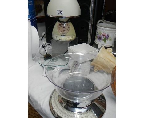 Three sets of scales and a clock/lamp/alarm.