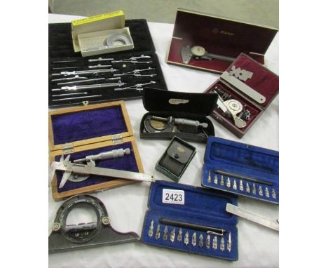 A mixed lot of gauges, a geometry set and other tools.